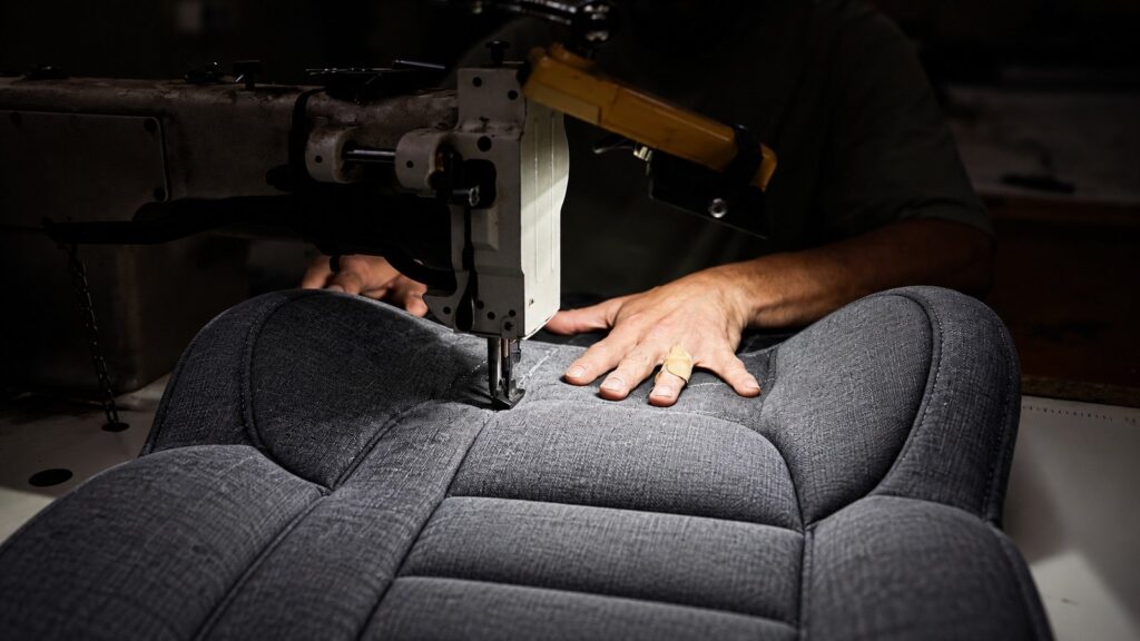 Industrial sewing machine stitching a child car seat cover