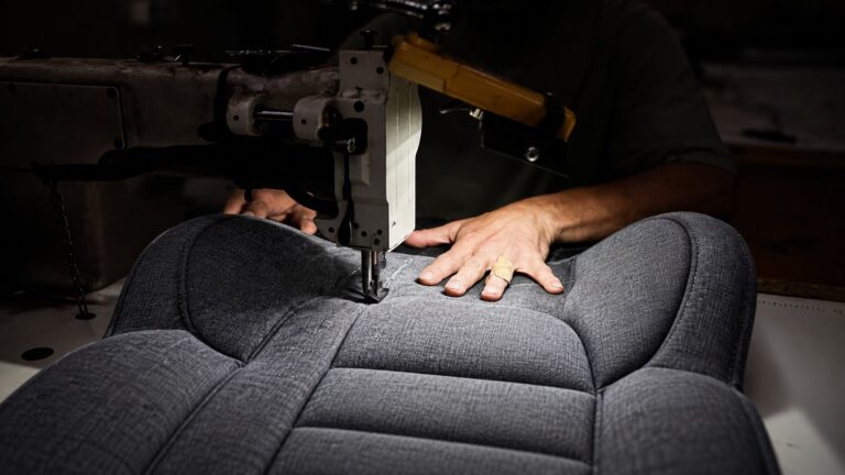 Industrial sewing machine stitching a child car seat cover